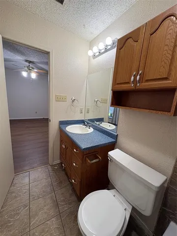 a bathroom with a toilet a sink and a mirror