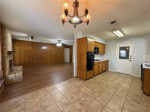 a view of a kitchen with furniture and wooden floor