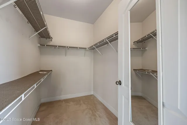 a large bedroom with a bed and a large window