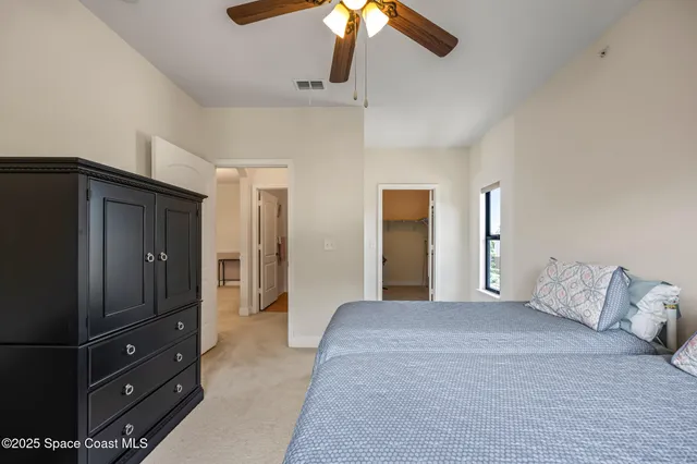 a spacious bedroom with a large bed and a large window