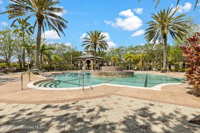 a swimming pool with outdoor seating and yard