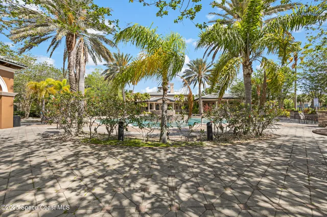 a balcony with furniture and a potted plant