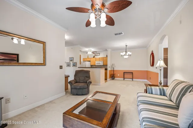 a living room with furniture and a chandelier