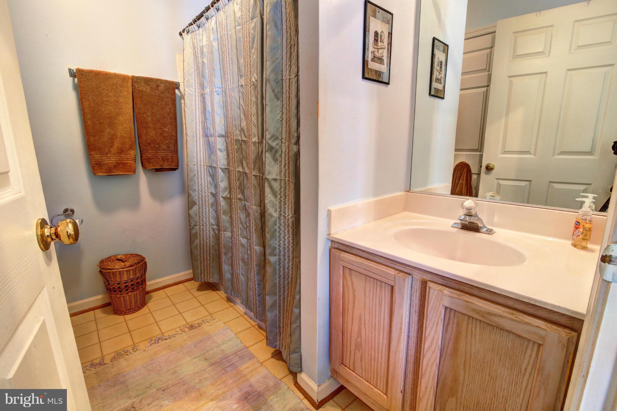 635 Constellation Square Southeast, Unit K Leesburg, VA 20175 - Photo 11 of 14 a bathroom with a sink and a mirror