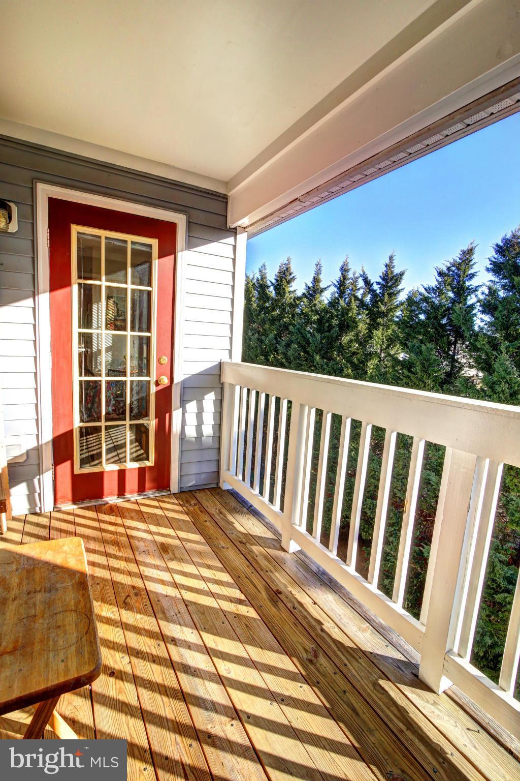 635 Constellation Square Southeast, Unit K Leesburg, VA 20175 - Photo 14 of 14 a view of a balcony with a floor to ceiling window and wooden floor