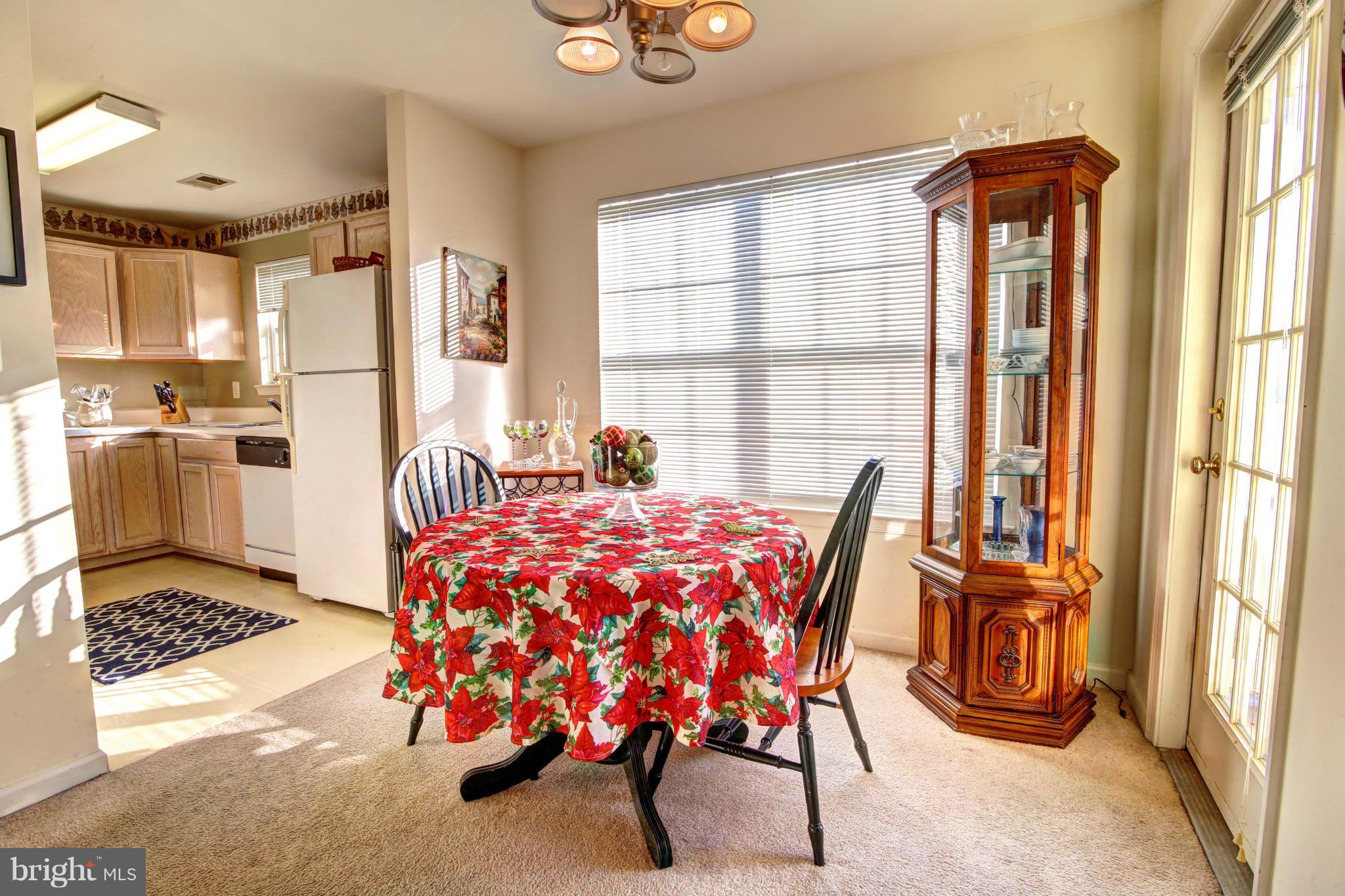 635 Constellation Square Southeast, Unit K Leesburg, VA 20175 - Photo 6 of 14 a bedroom with a bed and a table with windows
