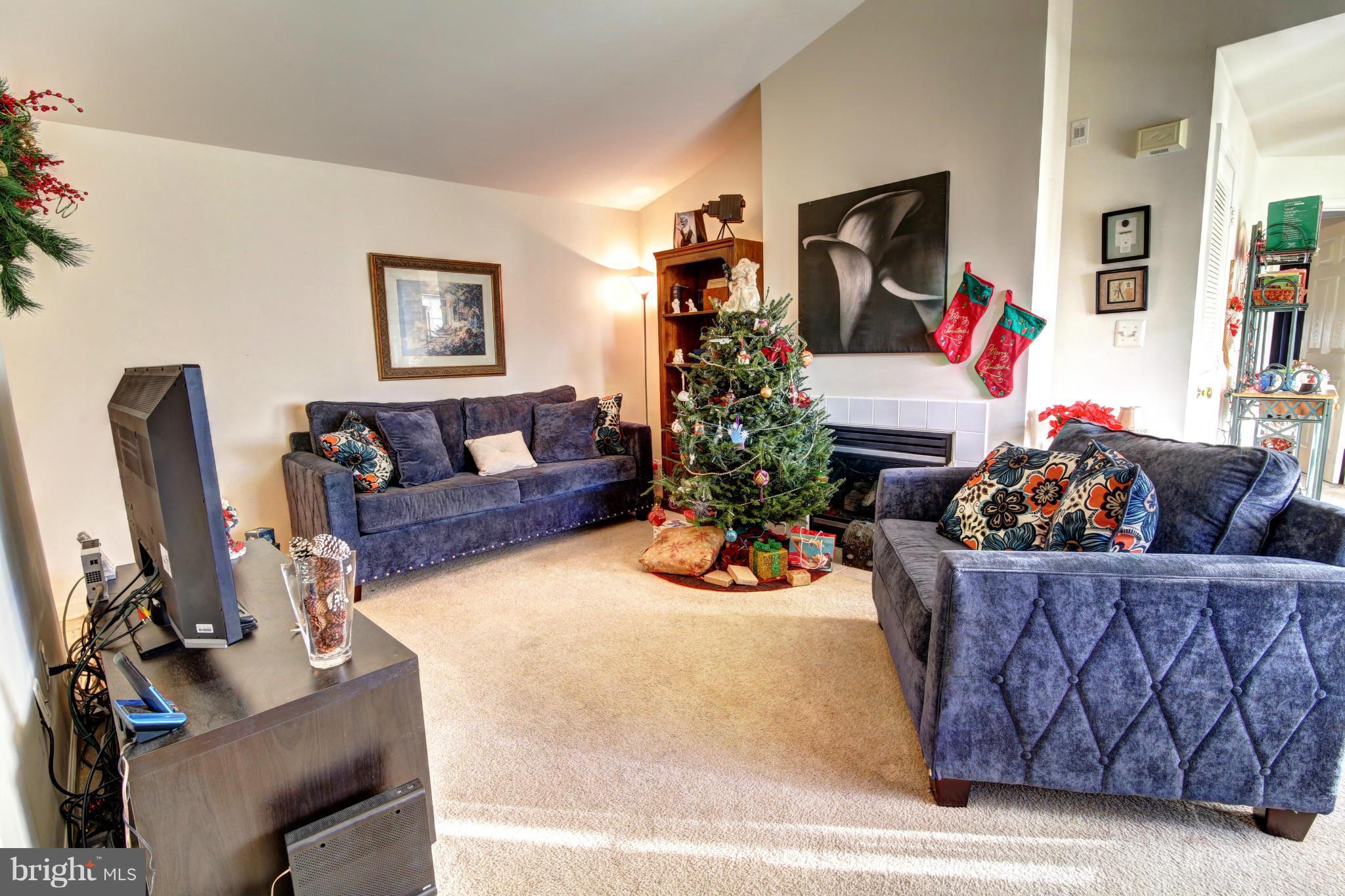 635 Constellation Square Southeast, Unit K Leesburg, VA 20175 - Photo 7 of 14 a living room with furniture and a flat screen tv