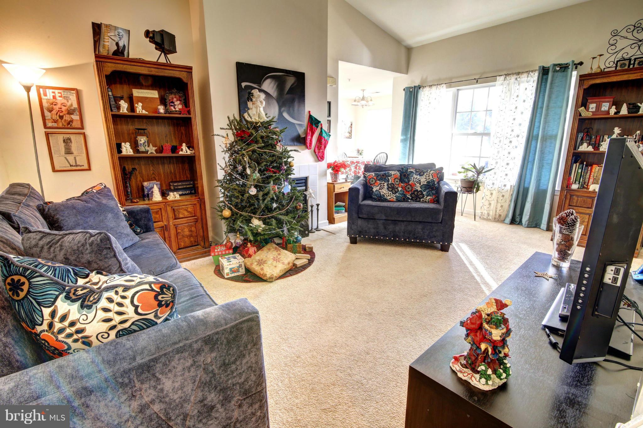 635 Constellation Square Southeast, Unit K Leesburg, VA 20175 - Photo 8 of 14 a living room with furniture and a flat screen tv