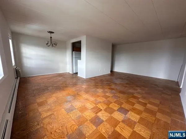 a view of a big room with windows and cabinet