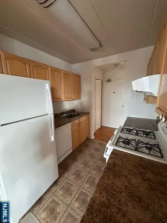 a kitchen with granite countertop a stove and a refrigerator