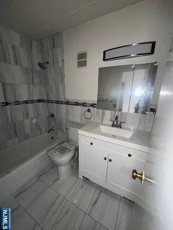 a bathroom with a double vanity sink toilet and shower