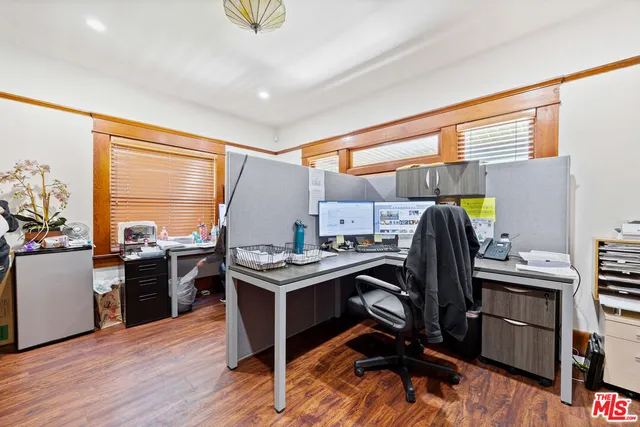 a view of a workspace with furniture and a window