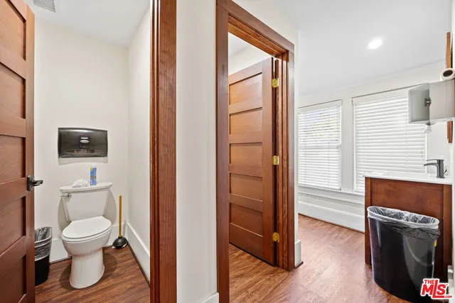 a bathroom with a toilet a sink and mirror