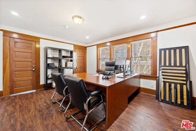 a view of a workspace with furniture and a window