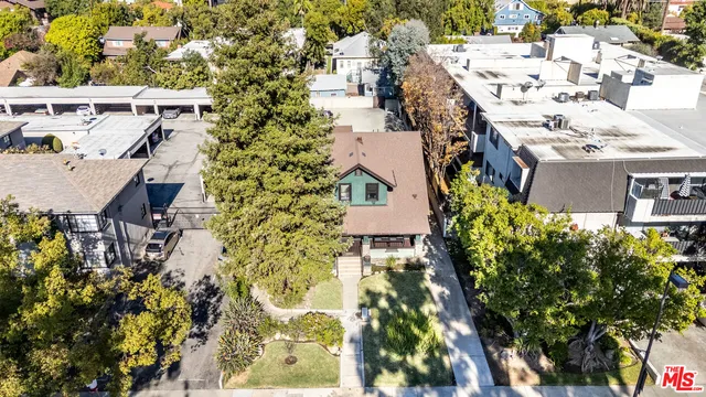 an aerial view of a house with a yard