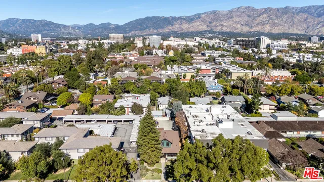 an aerial view of a residential houses with yard