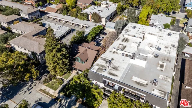 an aerial view of residential houses with outdoor space