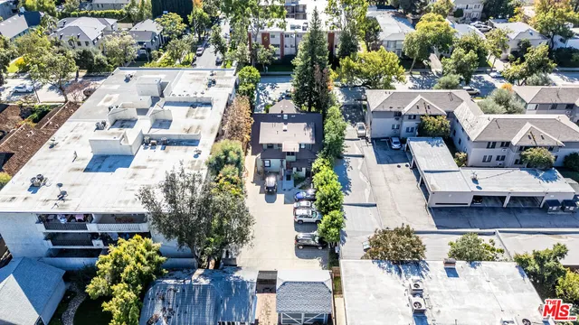 an aerial view of multiple houses with yard