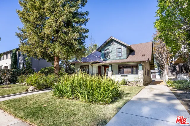 a front view of a house with a garden