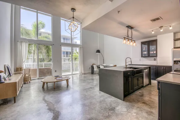 a large open kitchen with a large window and stainless steel appliances