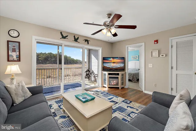a living room with furniture a large window and a table