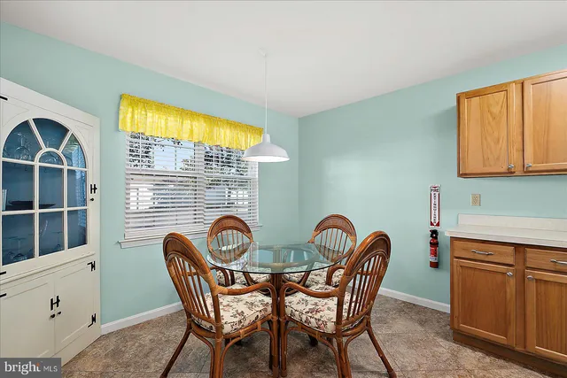 a view of a dining room with furniture and window