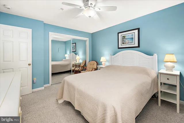 a bedroom with bed and paintings on the wall