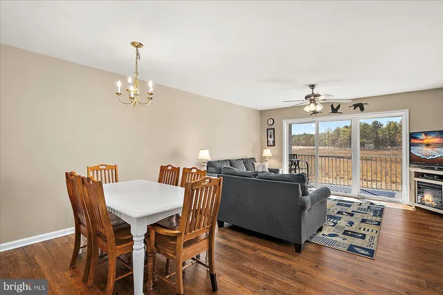 a view of a dining room with furniture wooden floor and chandelier