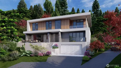 a front view of a house with a yard and trees