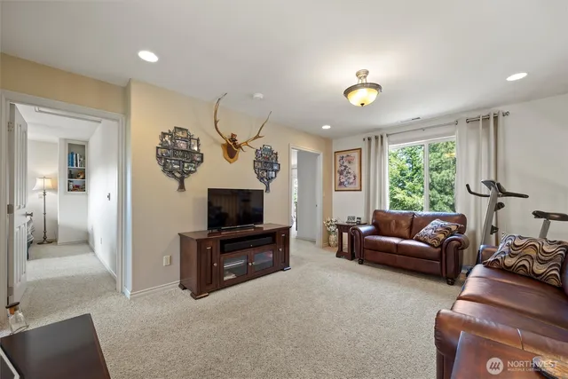 a living room with furniture a window and a flat screen tv