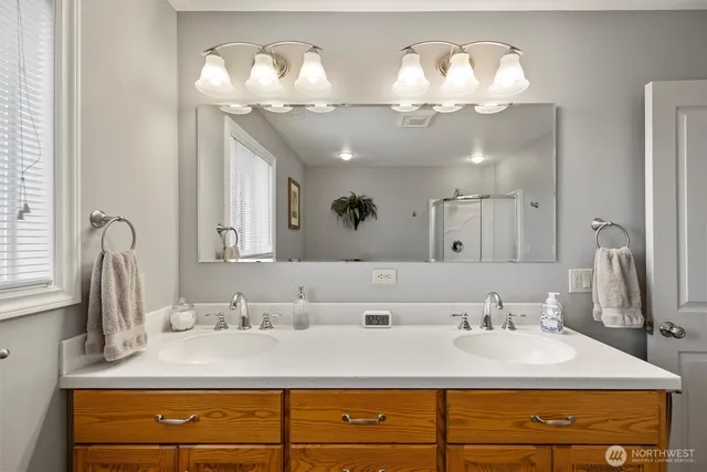 a bathroom with a sink double vanity and a mirror