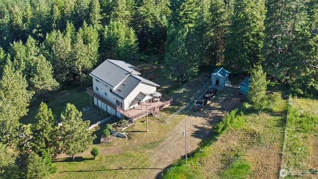 an aerial view of a house with a yard