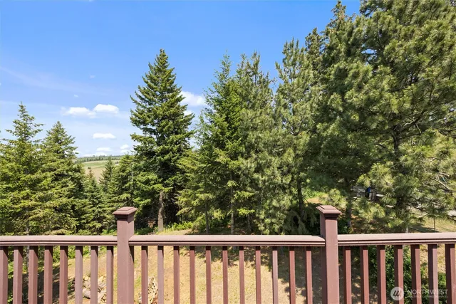 a view of a balcony with wooden fence and floor