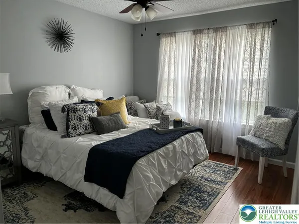 a bedroom with a bed and a chair