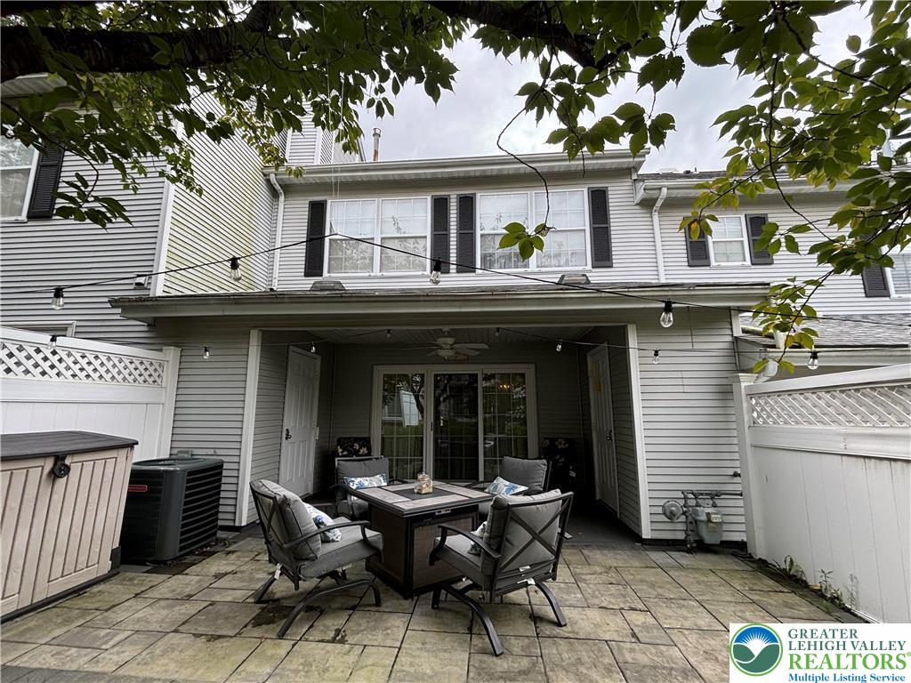 1963 Delancey Street Hellertown, PA 18055 - Photo 14 of 26 a view of house with patio outdoor seating and covered with trees