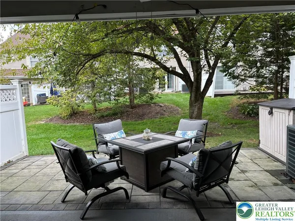 a backyard of a house with outdoor seating