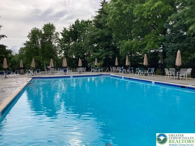 a kitchen with a table chairs wooden floor and stainless steel appliances