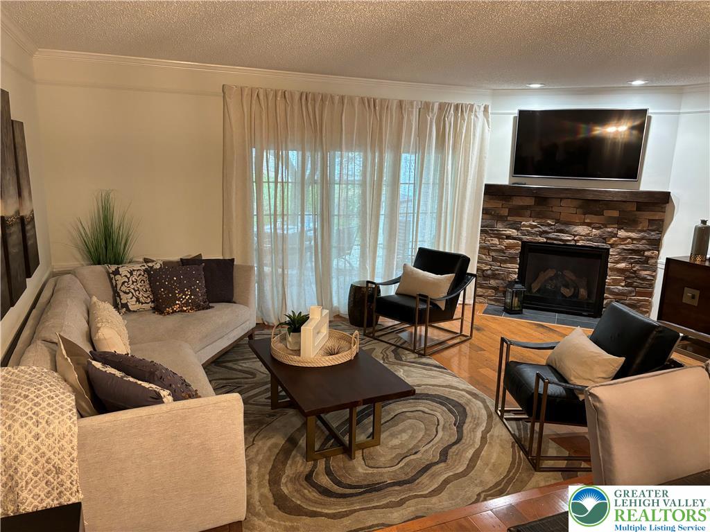 1963 Delancey Street Hellertown, PA 18055 - Photo 4 of 26 a living room with furniture a fireplace and a flat screen tv