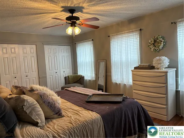 a bedroom with a bed and a chandelier