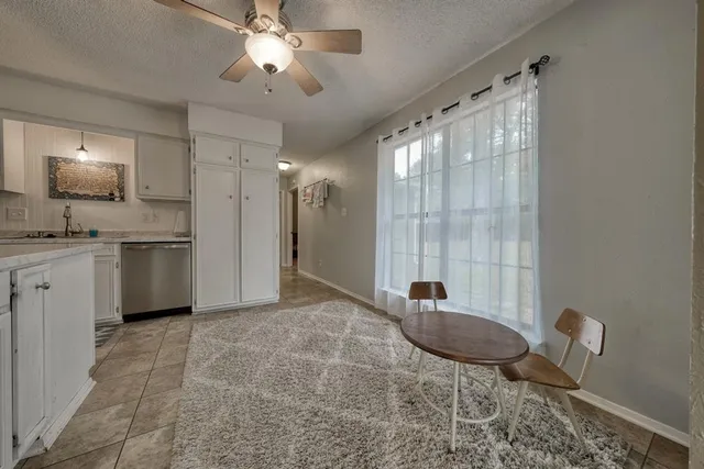 a living room with granite countertop furniture a sink and a chandelier
