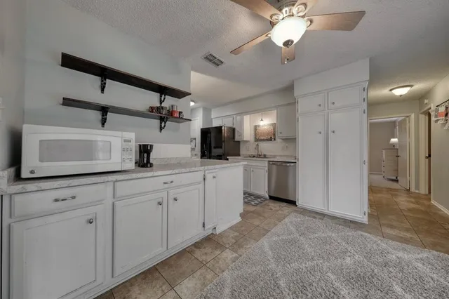 a kitchen with cabinets a sink and stainless steel appliances