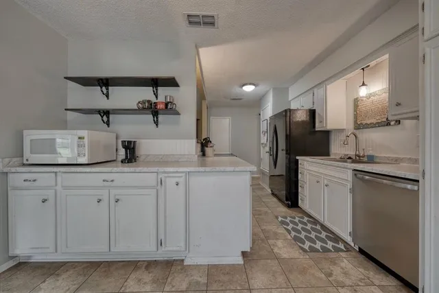 a kitchen with a sink and refrigerator