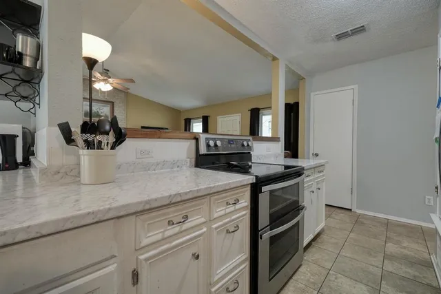 a kitchen with a sink and a stove top oven