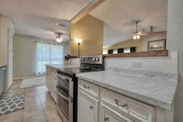 a kitchen with a sink and a stove top oven