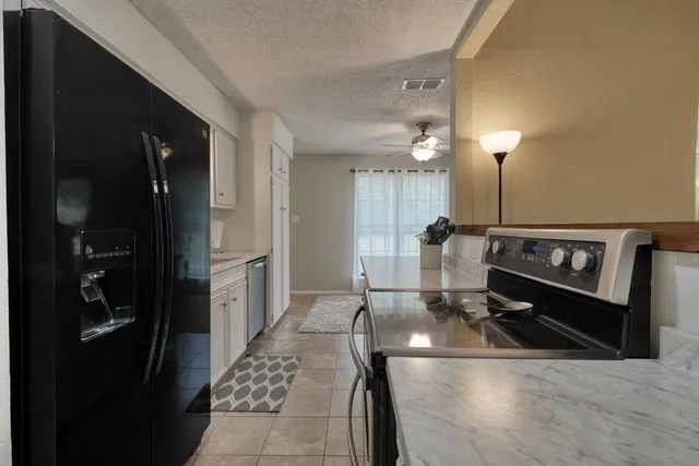 a kitchen with a sink and refrigerator