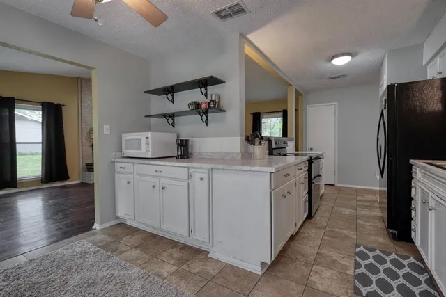 a kitchen with sink cabinets and refrigerator
