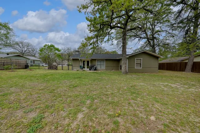a front view of house with yard and green space
