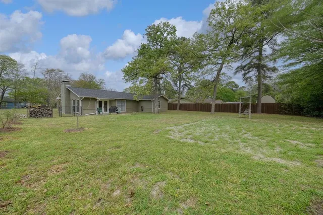 a view of house with a backyard