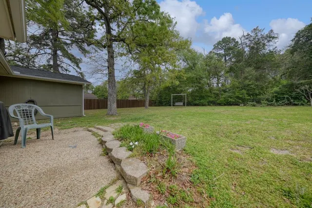 a backyard of a house with table and chairs