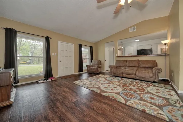 a living room with a bed furniture and a window